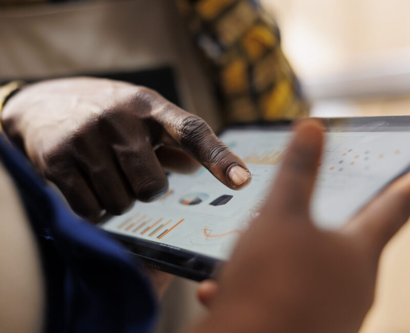 African american warehouse worker hand pointing at inventory statistics on tablet. Storehouse employee asking supervisor about products distribution analytics report and tapping on screen close up